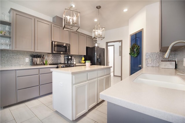 7002 Madiera Dr, Corpus Christi, TX 78414 - kitchen featuring stainless steel appliances, a chandelier, decorative backsplash, gray cabinets, and recessed lighting