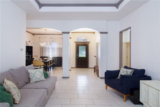 7002 Madiera Dr, Corpus Christi, TX 78414 - living area featuring arched walkways, a chandelier, ornate columns, crown molding, and a tray ceiling