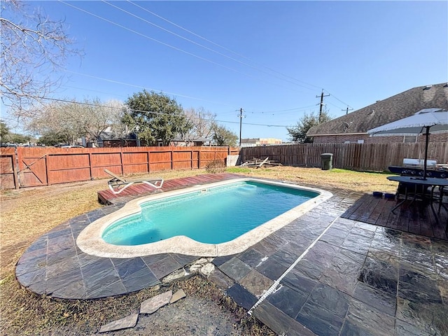 view of swimming pool featuring a fenced in pool, a fenced backyard, and a patio area