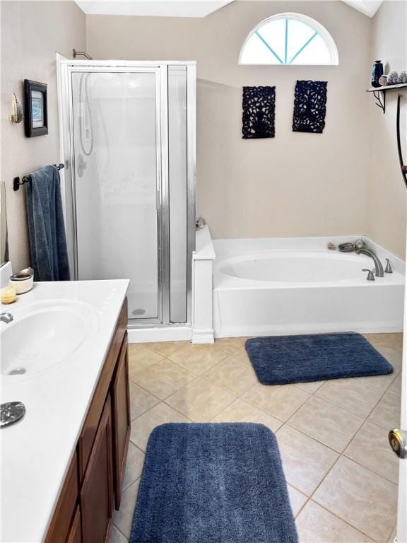 full bath with tile patterned floors, a shower stall, lofted ceiling, a bath, and vanity