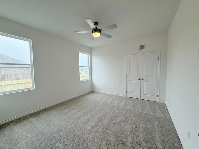 carpeted empty room with ceiling fan