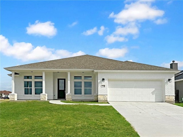 view of front of home with a front yard and a garage