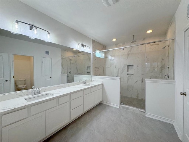 bathroom with tile patterned flooring, vanity, toilet, and an enclosed shower