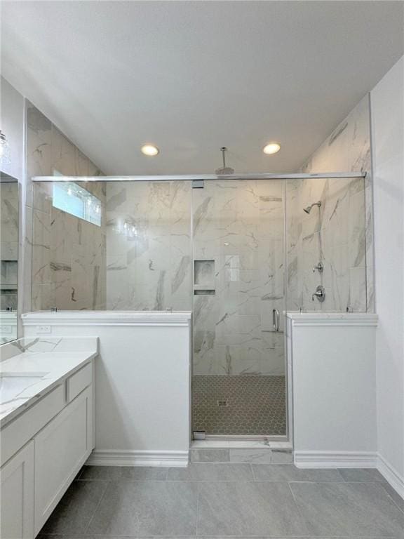 bathroom with vanity, tile patterned floors, and a shower with door