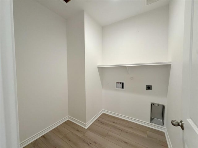 washroom with washer hookup, electric dryer hookup, light hardwood / wood-style floors, and hookup for a gas dryer