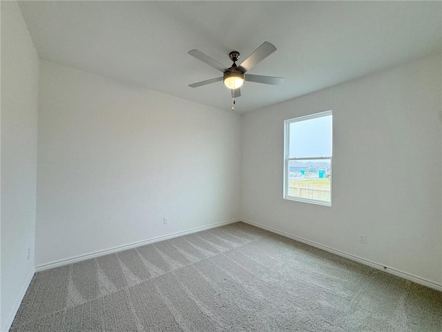 spare room with carpet floors and ceiling fan