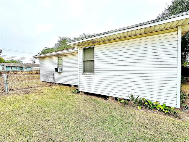 view of side of home with a lawn and cooling unit