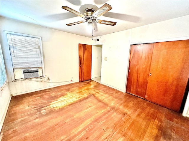 unfurnished bedroom featuring a closet, ceiling fan, light hardwood / wood-style flooring, and cooling unit