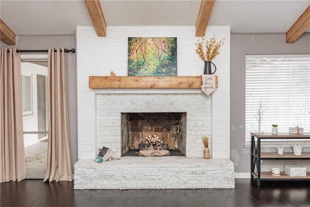 interior details featuring beam ceiling, wood walls, a fireplace, and wood-type flooring