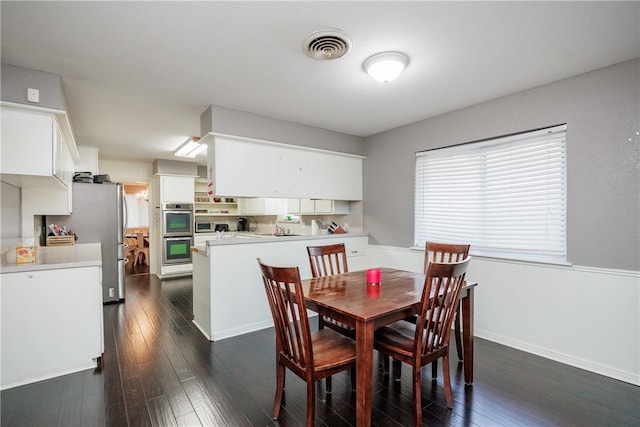 dining area with dark hardwood / wood-style flooring and sink