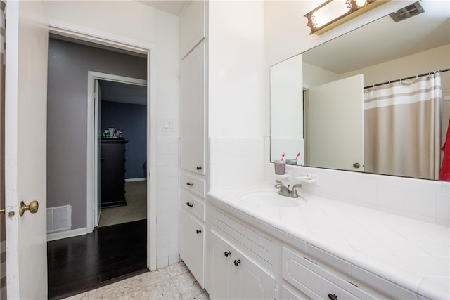 bathroom with hardwood / wood-style flooring and vanity