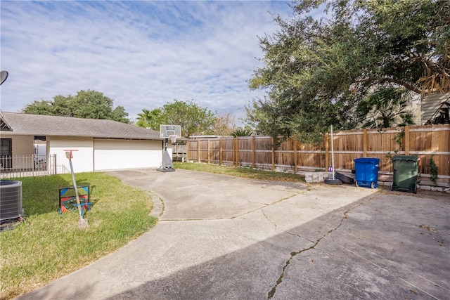 exterior space with a garage and central air condition unit