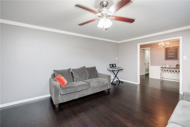 living room with ceiling fan with notable chandelier, crown molding, and dark wood-type flooring