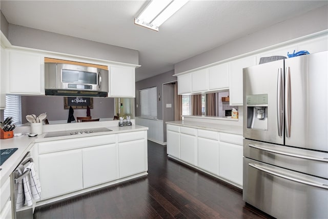 kitchen with dark hardwood / wood-style flooring, white cabinets, a textured ceiling, and appliances with stainless steel finishes