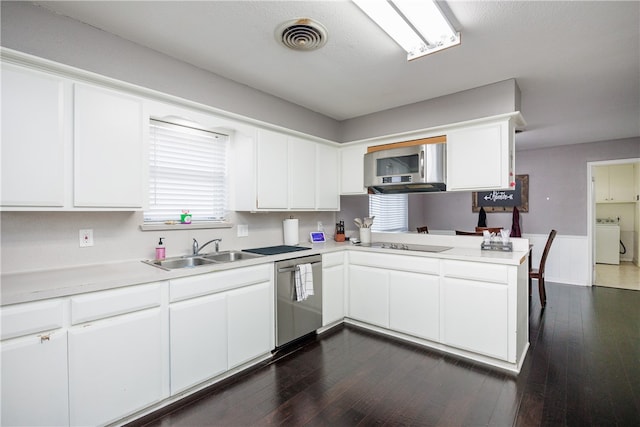 kitchen with kitchen peninsula, dark hardwood / wood-style flooring, stainless steel appliances, washer / clothes dryer, and white cabinetry