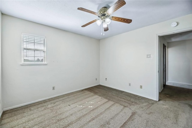 spare room featuring carpet and ceiling fan