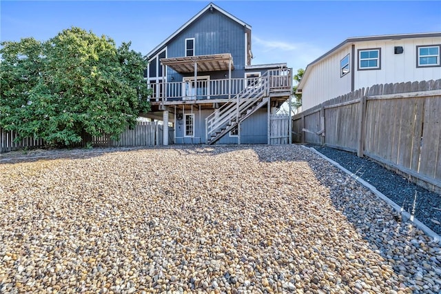 rear view of house featuring a wooden deck