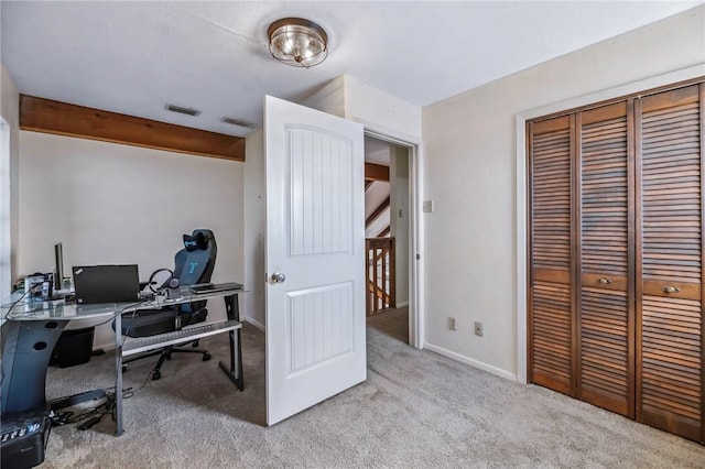 office space with light carpet and beam ceiling