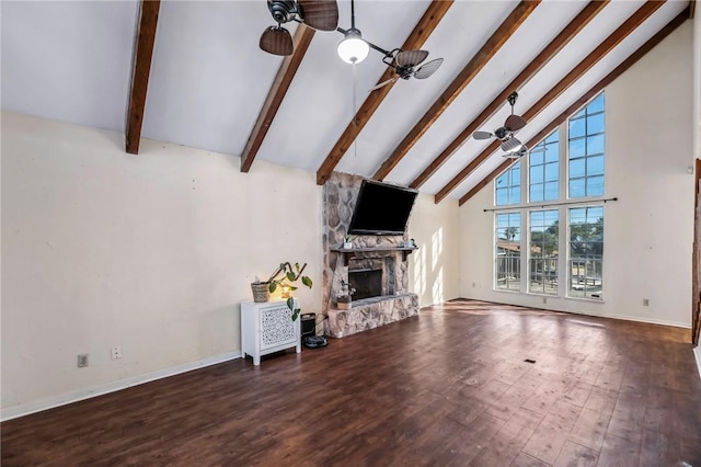 unfurnished living room featuring high vaulted ceiling, beamed ceiling, ceiling fan, a fireplace, and hardwood / wood-style floors