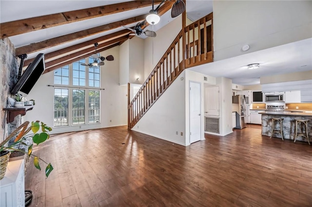 living room with beamed ceiling, high vaulted ceiling, dark hardwood / wood-style floors, and ceiling fan