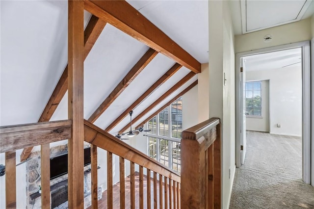 corridor featuring carpet and vaulted ceiling with beams