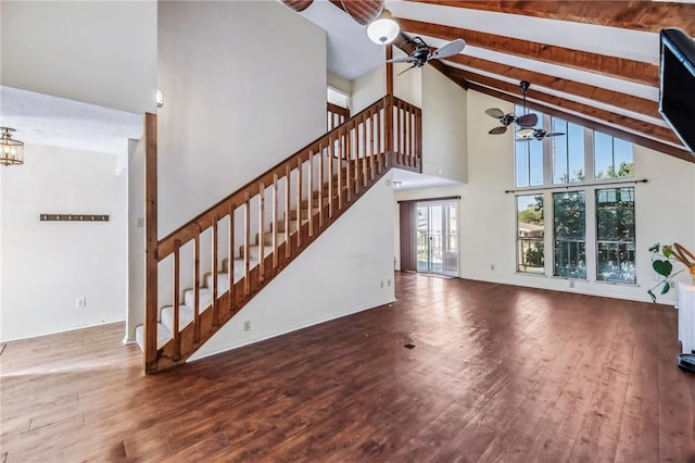 unfurnished living room with high vaulted ceiling, ceiling fan with notable chandelier, hardwood / wood-style floors, and beam ceiling