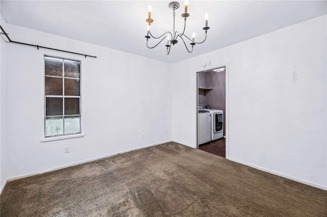 empty room featuring independent washer and dryer, a chandelier, and dark colored carpet