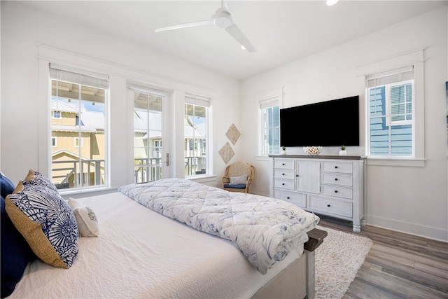 bedroom with wood-type flooring, access to outside, and ceiling fan