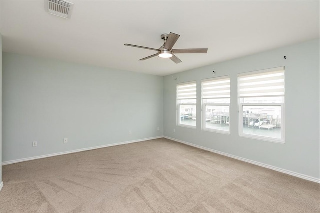 carpeted empty room featuring ceiling fan