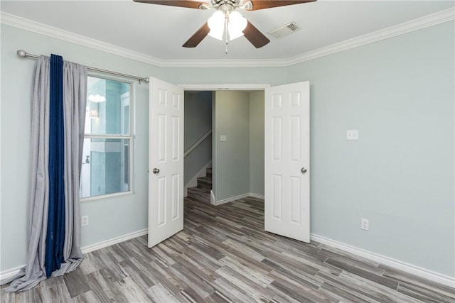 unfurnished bedroom featuring hardwood / wood-style floors, ceiling fan, and ornamental molding