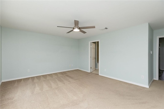 spare room featuring light carpet and ceiling fan