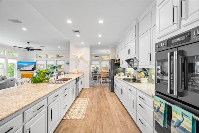 2110 Harbor Ct, Rockport, TX 78382 - kitchen with freestanding refrigerator, a sink, white cabinetry, black electric cooktop, and recessed lighting