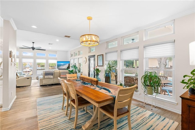 2110 Harbor Ct, Rockport, TX 78382 - dining room with a chandelier, recessed lighting, light wood-type flooring, a ceiling fan, and ornamental molding