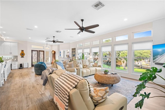 2110 Harbor Ct, Rockport, TX 78382 - living area with ornamental molding, a ceiling fan, recessed lighting, and light wood-style floors