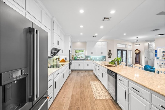 2110 Harbor Ct, Rockport, TX 78382 - kitchen with stainless steel appliances, white cabinetry, light wood finished floors, recessed lighting, and a sink