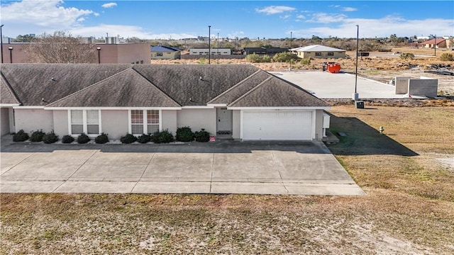 ranch-style house with a garage and a front lawn