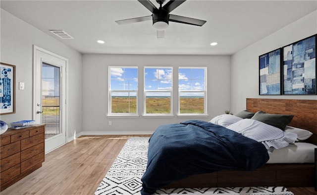 bedroom with visible vents, baseboards, light wood-style flooring, access to exterior, and recessed lighting