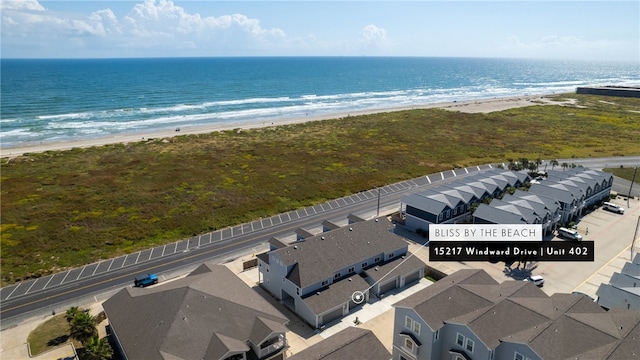 drone / aerial view featuring a beach view and a water view