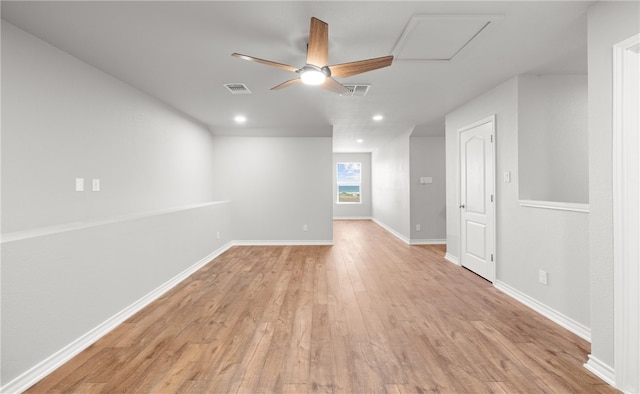 spare room featuring baseboards, visible vents, and light wood-style floors