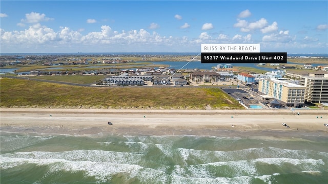 birds eye view of property featuring a water view and a view of the beach