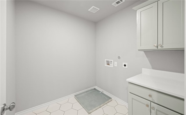 clothes washing area featuring cabinet space, visible vents, washer hookup, and electric dryer hookup