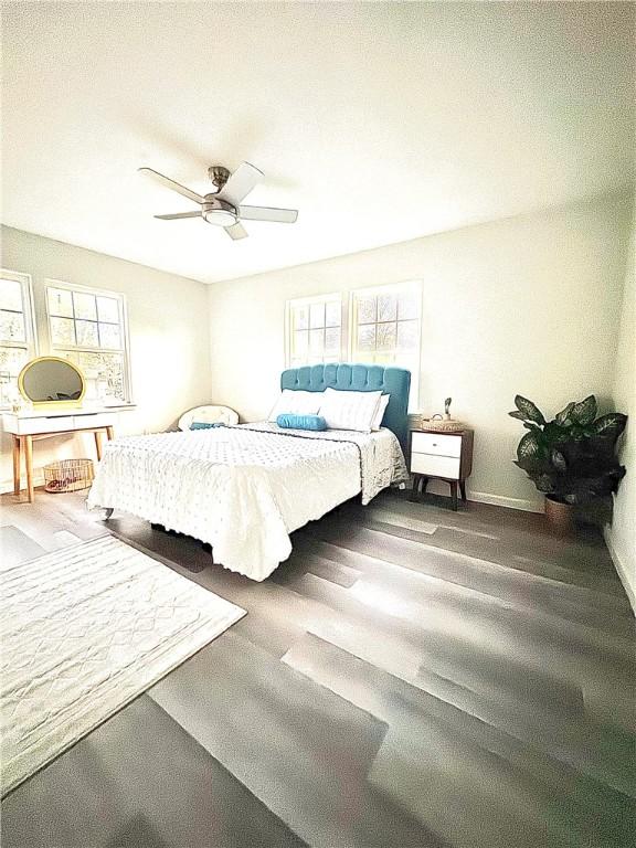 bedroom with wood finished floors and a ceiling fan