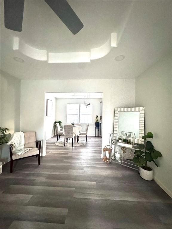 living area featuring dark hardwood / wood-style floors and ceiling fan