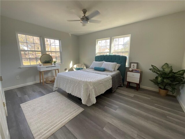 bedroom featuring ceiling fan, wood finished floors, and baseboards