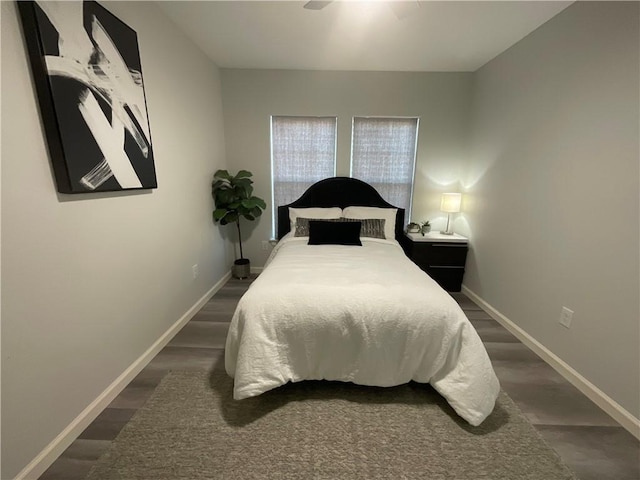 bedroom featuring baseboards and wood finished floors