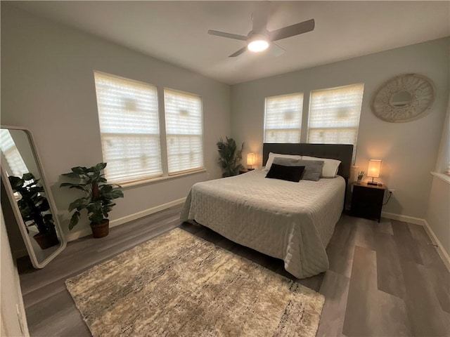 bedroom featuring ceiling fan, wood finished floors, and baseboards