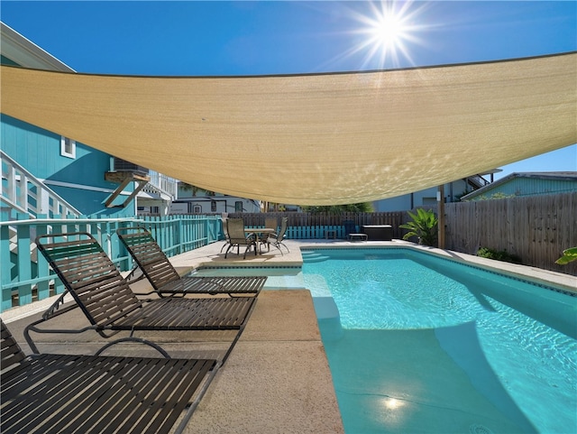 view of swimming pool with a patio area