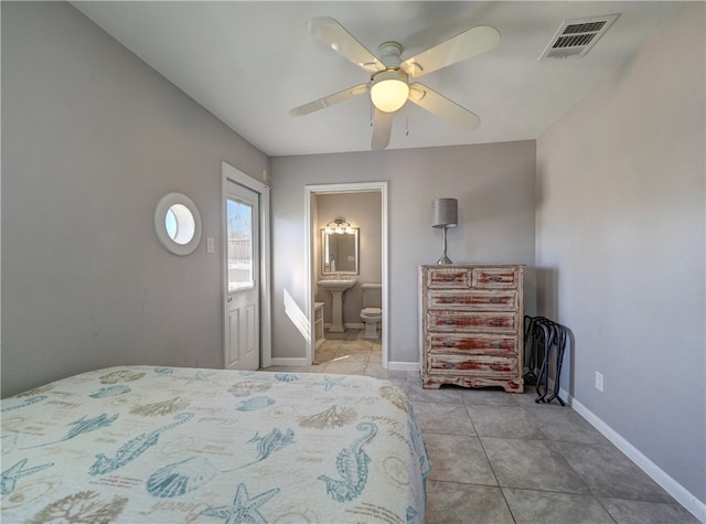 unfurnished bedroom with light tile patterned floors, ensuite bath, and ceiling fan