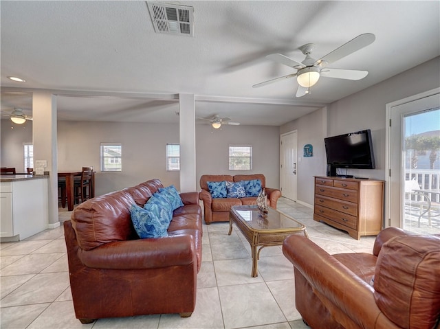 tiled living room featuring a textured ceiling