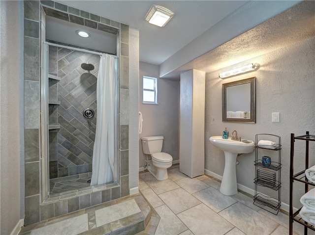 bathroom with curtained shower, tile patterned flooring, a textured ceiling, and toilet